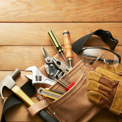 tools in tool belt on wood planks with copy space